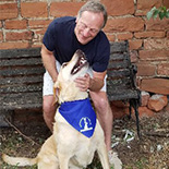 man with yellow lab